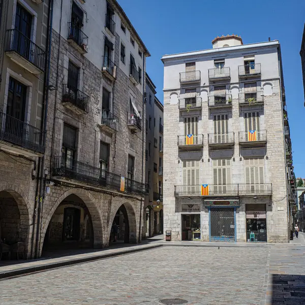 stock image Girona, Spain - 23 July, 2024: Historic buildings in the Plaza del Vi, Girona, Catalonia