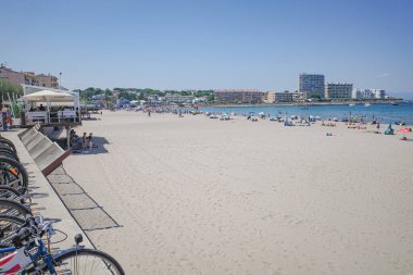 L'Escala, Spain - June 01 2019: City beach in the town of L'Escala, Costa Brava clipart