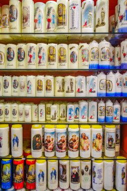 Lourdes, France - 1 Nov, 2024: Virgin Mary Statues, Candles and other Catholic memorabilia on sale in a gift shop in Lourdes clipart