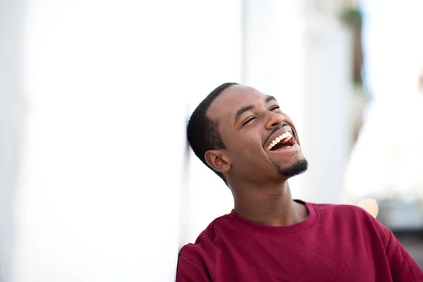 Closeup Portrait Handsome Young African Man Leaning White Wall Smiling — Stock Photo, Image