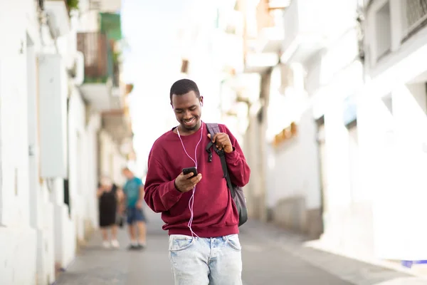 Portrait Smiling Young Black Man Mobile Phone Listening Music Earphones — Stock Photo, Image