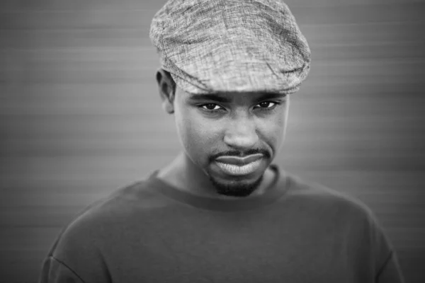 Κοντινό Ασπρόμαυρο Πορτραίτο Του Νεαρού Μαύρου Καπέλο Κοιτάζει Την Κάμερα — Φωτογραφία Αρχείου