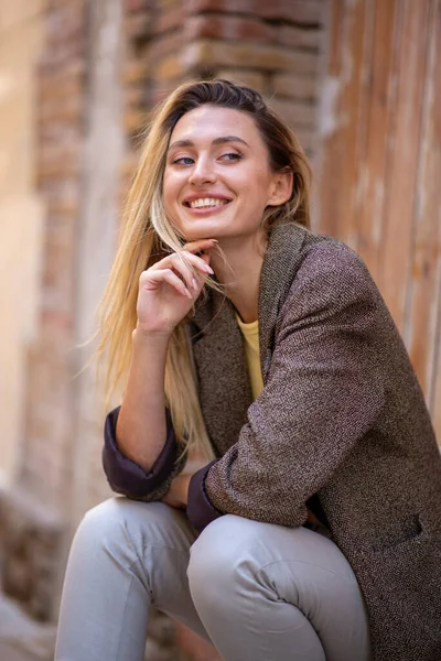 Portrait of happy woman looking away while sitting outdoors