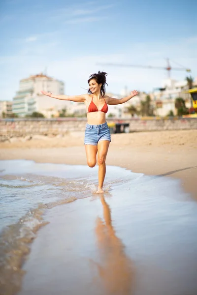 Full Length Portrait Carefree Young Woman Running Beach Arms Outstretched — Stock Photo, Image