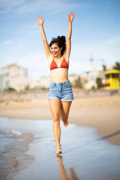 Full Length Portrait Carefree Young Woman Running Beach Arms Raised — Stock Photo, Image