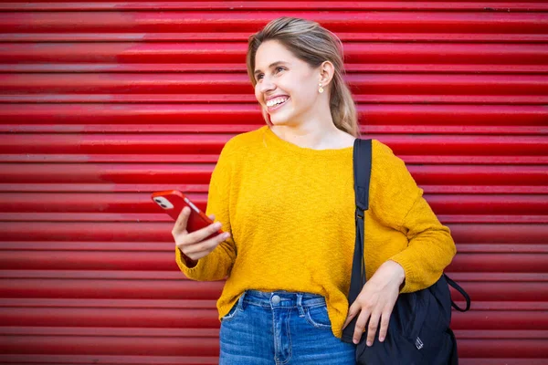 Portrait Smiling Young Woman Phone Standing Front Red Shutter — Stock Photo, Image