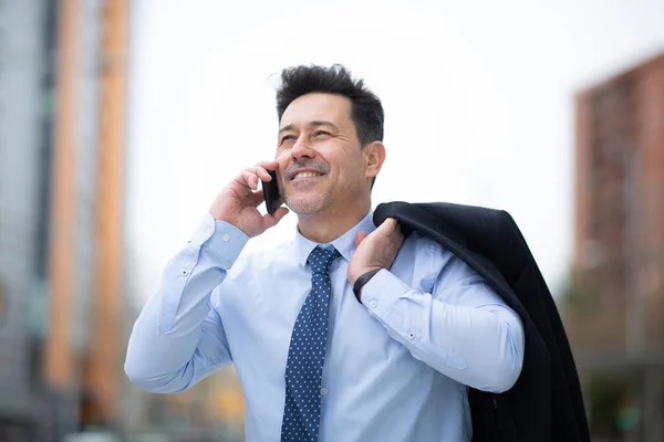 Portrait Smiling Mature Businessman Standing Holding Coat Shoulder Talking Phone — Stock Photo, Image