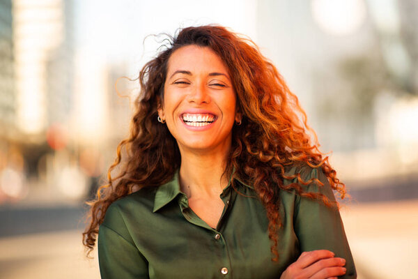 Close up portrait of beautiful young hispanic woman smiling outside on a summer day