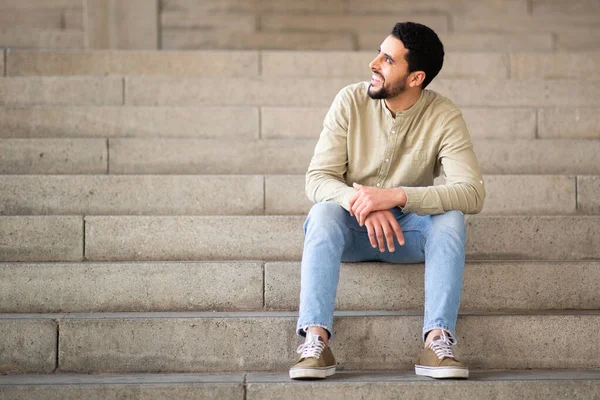 Full Length Portrait Young Man Sitting Steps Looking Away Smiling — Stock Photo, Image