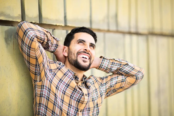 Portrait Happy Young Arabic Guy Leaning Wall Hands Head Looking — Stock Photo, Image