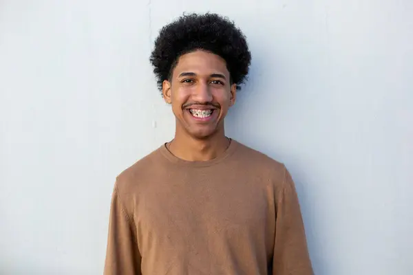 Voorportret Glimlachende Afrikaanse Amerikaanse Man Door Witte Muur — Stockfoto