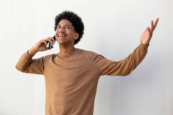 portrait of a cool and fashionable African-American man talking with mobile phone
