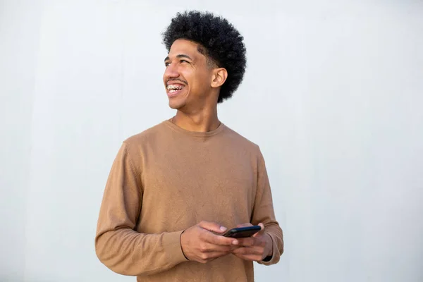 Smiling Hispanic Man Holding Phone White Wall — Stok Foto