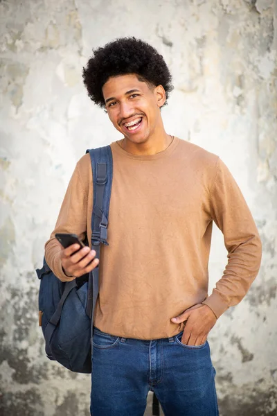 Portrait happy young man with mobile phone in hand