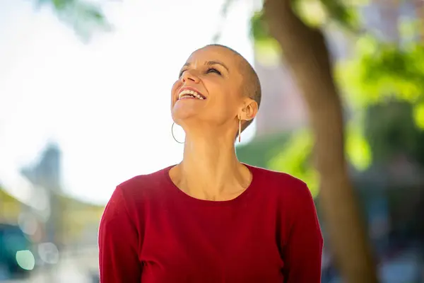Portrait of woman with shaved head laughing