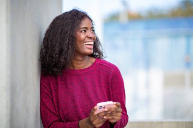 Açık havada telefonla gülen mutlu bir kadının samimi portresi