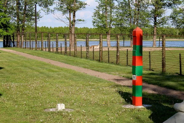 Country Border. Razor Wire Fencing on Border with Russia. USSR Border Post