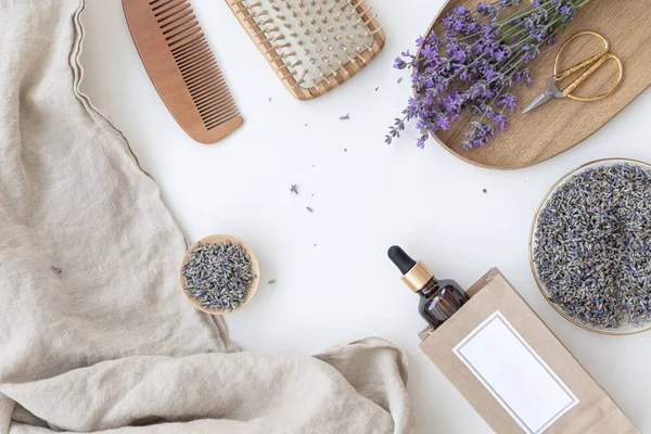 Stock image Amber bottle of lavender essential oil. Flat lay concept skin care. Light background with lavend flower