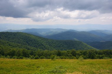 nature scenery with hills and meadows. summer mountain landscape with clouds on the sky