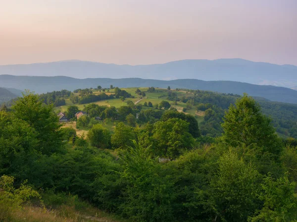 stock image rural mountain scenery in summer. stunning sunset view over the valley with trees and meadows on the rolling hills