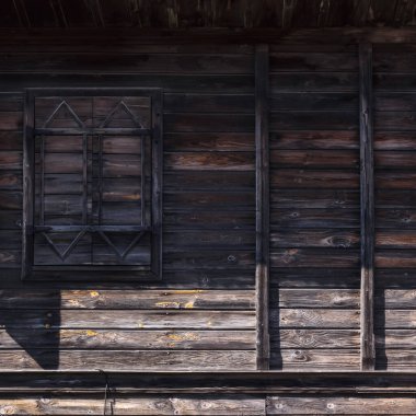 windows on the wooden facade in bulgaria. architectural retro elemet background