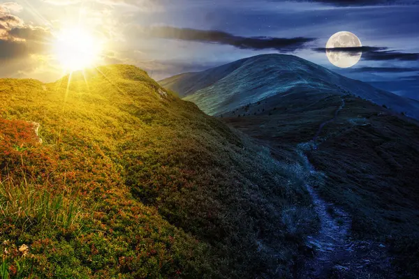 summer mountain landscape with sun and moon at twilight. foot path through hill side to the mountain top. day and night time change concept. mysterious countryside scenery in morning light