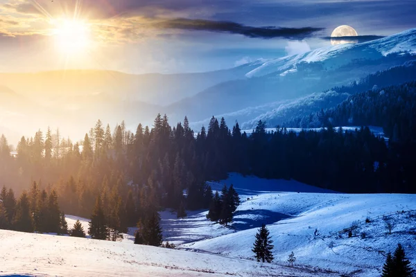 winter solstice in carpathian mountains. landscape with forested snow covered hills beneath a sky with sun and moon. day and night time change concept