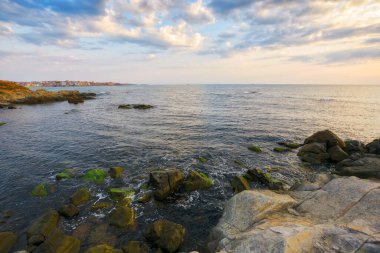 black sea scenery at sunrise. bright cloudy sky. leisure background