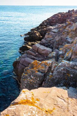 Yazın deniz kıyısında kayalık kıyı manzarası. Ufuk üzerinde mavi ve kıyı manzarası olan güzel deniz manzarası. İspanya 'nın tatil sezonunda deniz manzarası