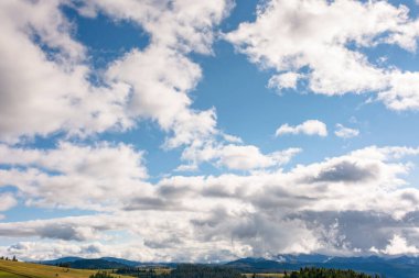 Eylül 'de dağların üzerindeki mavi gökyüzünde ağır bulutlar. Dramatik manzara. Karpatlar üzerinde sonbahar erken bulutlu hava. dinamik oluşum
