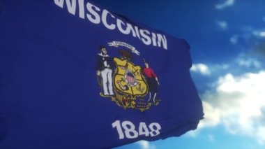 Rüzgarda dalgalanan bayrak direğinde Wisconsin bayrağı, mavi gökyüzü arka planı.