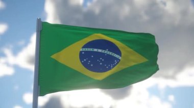 Brezilya 'nın ulusal bayrağı rüzgarda dalgalanıyor, mavi gökyüzü arka planı. 4K.