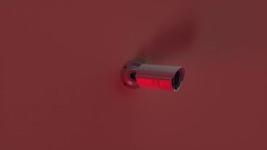 Güvenlik kameraları hedefi takip ediyor. Kırmızı alarm. Üzerinde beyaz kamera olan kırmızı bir duvar..