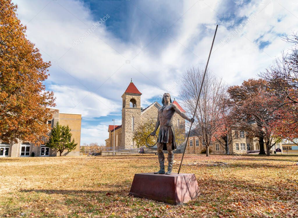 LAWRENCE, KS, USA - NOVEMBER 2, 2022: Apache Hoop and Pole Game Player scupture at Haskell Indian Nations University.