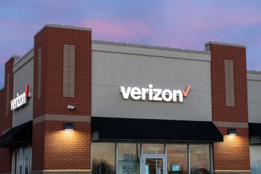 STILLWATER, MN, USA - DECEMBER 7, 2023: Verizon retail store exterior at dusk and trademark logo. clipart