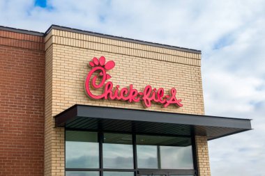 CHANHASSEN, MN, USA - JANUARY 2, 2024: Chick-Fil-A restaurant exterior and trademark logo.