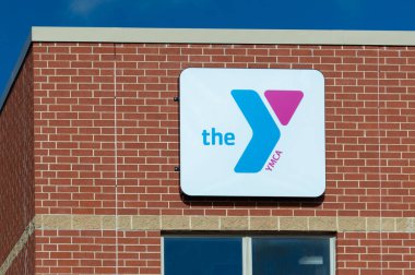 HUDSON, WI, USA - MARCH 9, 2024: YMCA fitness club exterior sign and trademark logo. clipart