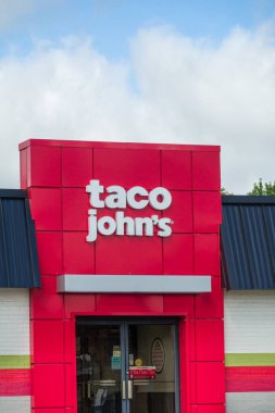 HUDSON, WI, USA - AUGUST 27, 2024: Taco John's exterior sign and trademark logo. clipart