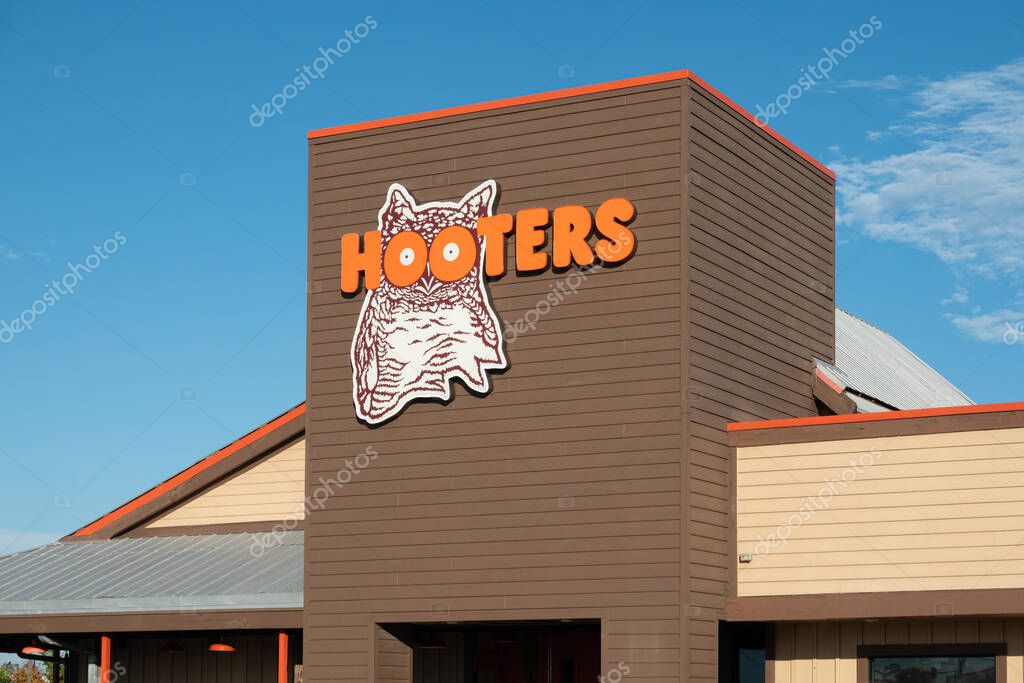 DOWNERS GROVE, IL, USA, SEPTEMBER 21, 2024: Hooters restaurant exterior and trademark logo.