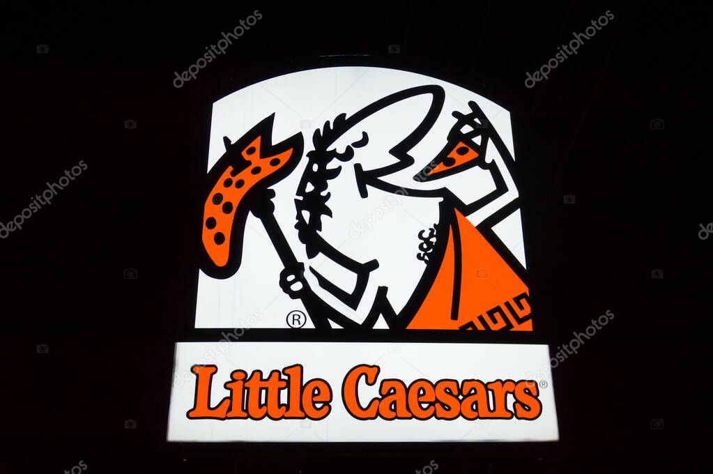 SIOUX FALLS, SD, USA, NOVEMBER 19, 2024: Little Caesars restaurant exterior sign at night and trademark logo.