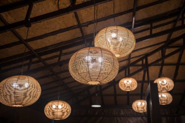 bamboo lantern circle lamp hanging on ceiling decorated inside resort or hotel. Light up at night