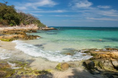 Motion wave at Ko Man Klang beach against blue sky in sunny day, Rayong, Thailand. Summer holiday maker or vacation in tropical country, Siam.