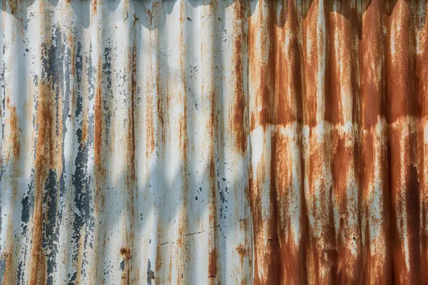 Rusty iron zinc or old corrugated metal barn wall. Closeup material textured background