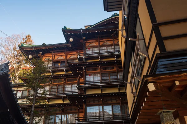 Traditional Japanese ryokan hotel in Shibu onsen town in morning, Yamanouchi, Nagano Japan. Historic resort exterior is model for the Hot Springs in Spirited Away movie.