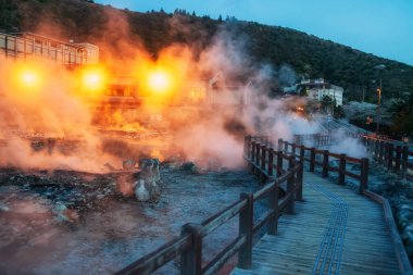 Jigoku Dağı 'nda geceleri Shimabara şehri, Nagasaki, Kyushu, Japonya' nın ışıklarıyla sülfür gazı kaplıcaları ve otel bulunur. Sıcak su, gaz ve buhar topraktan fışkırıyor..