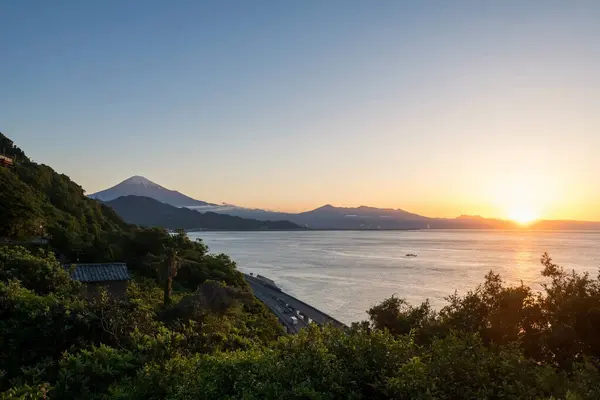 stock image Mount Fuji and expressway view from Satta Toge pass at sunrise with reflection on sea, Shimizu, Shizuoka, Japan. Famous photography aerial view spot for tourist people.