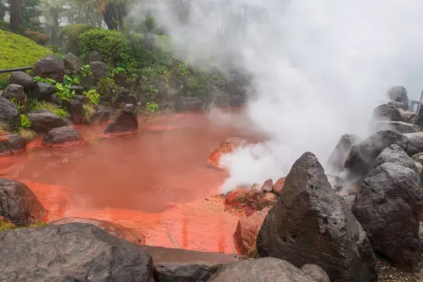 stock image Chinoike Jigoku Blood hell pond with white steam in Beppu, Oita, Japan. Here is pond of hot red water and famous photogenic of the eight hells.