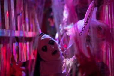 Kafesteki korkunç şeytani rahibe ve gelinlik içinde intihar gelini. 2024 Cadılar Bayramı konsepti parti maskesi ve kostüm .