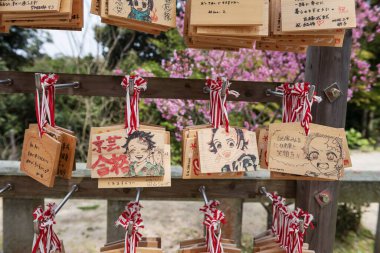 demon slayer character fan art painted on ema or prayer wooden boards in Homangu Kamado shrine, Dazaifu. Kyushu. clipart