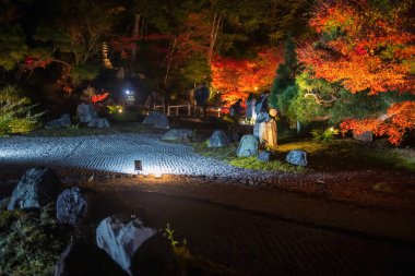 Rock garden with colorful maple leaves light up of Kurodani Konkai Komyoji temple park illumination, Kyoto, Japan. Famous travel destination for tourist sightseeing Kansai for fall illusion. clipart